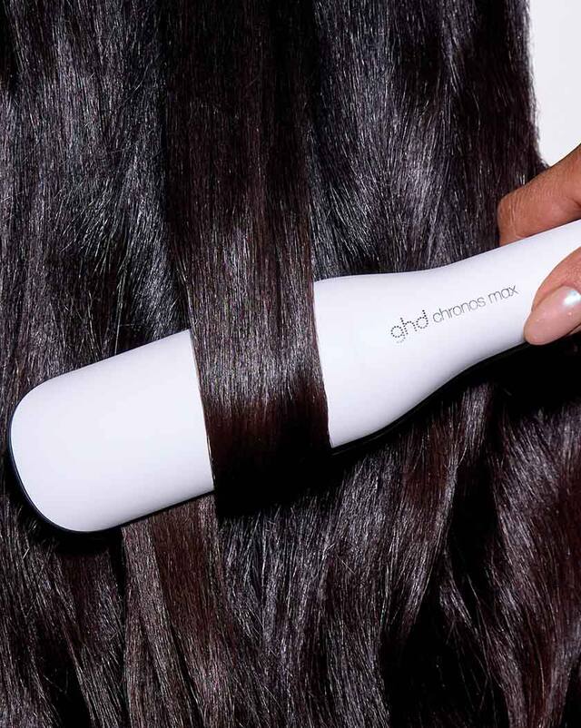weißes ghd chronos max Glätteisen mit breiten Platten in brünettem Haar